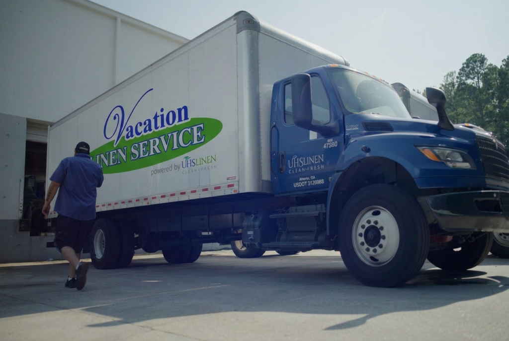 UHS Linen delivery truck with Vacation Linen Services logo on the side